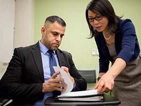 Two people looking at paperwork together