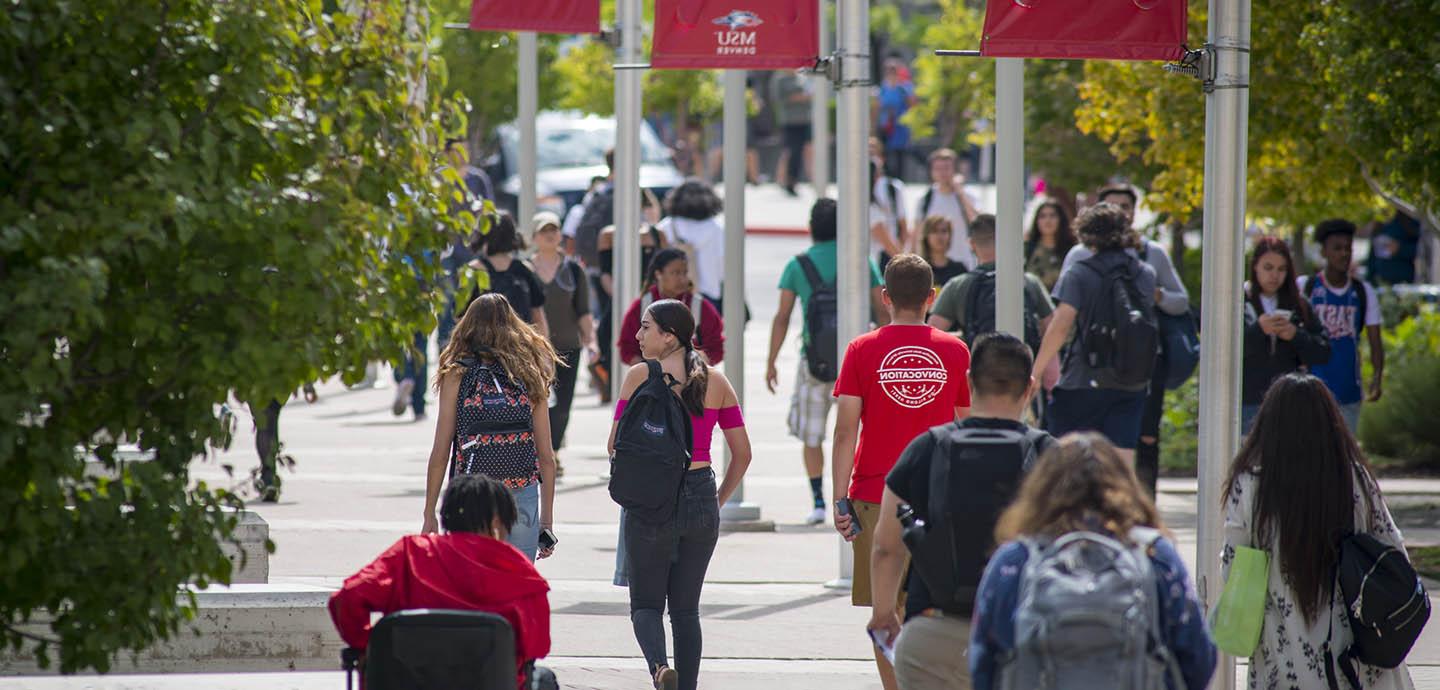 Students walking on Auraria campus in summer with MSU Denver banners above