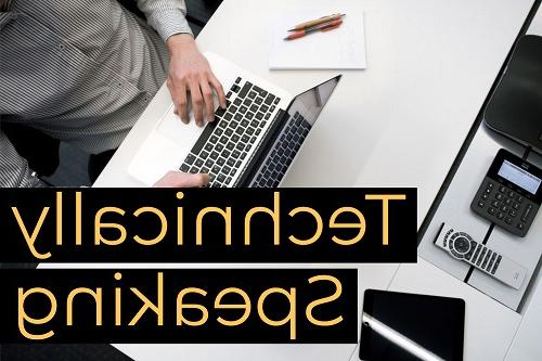 Close up of a man working on a laptop at his office desk. 