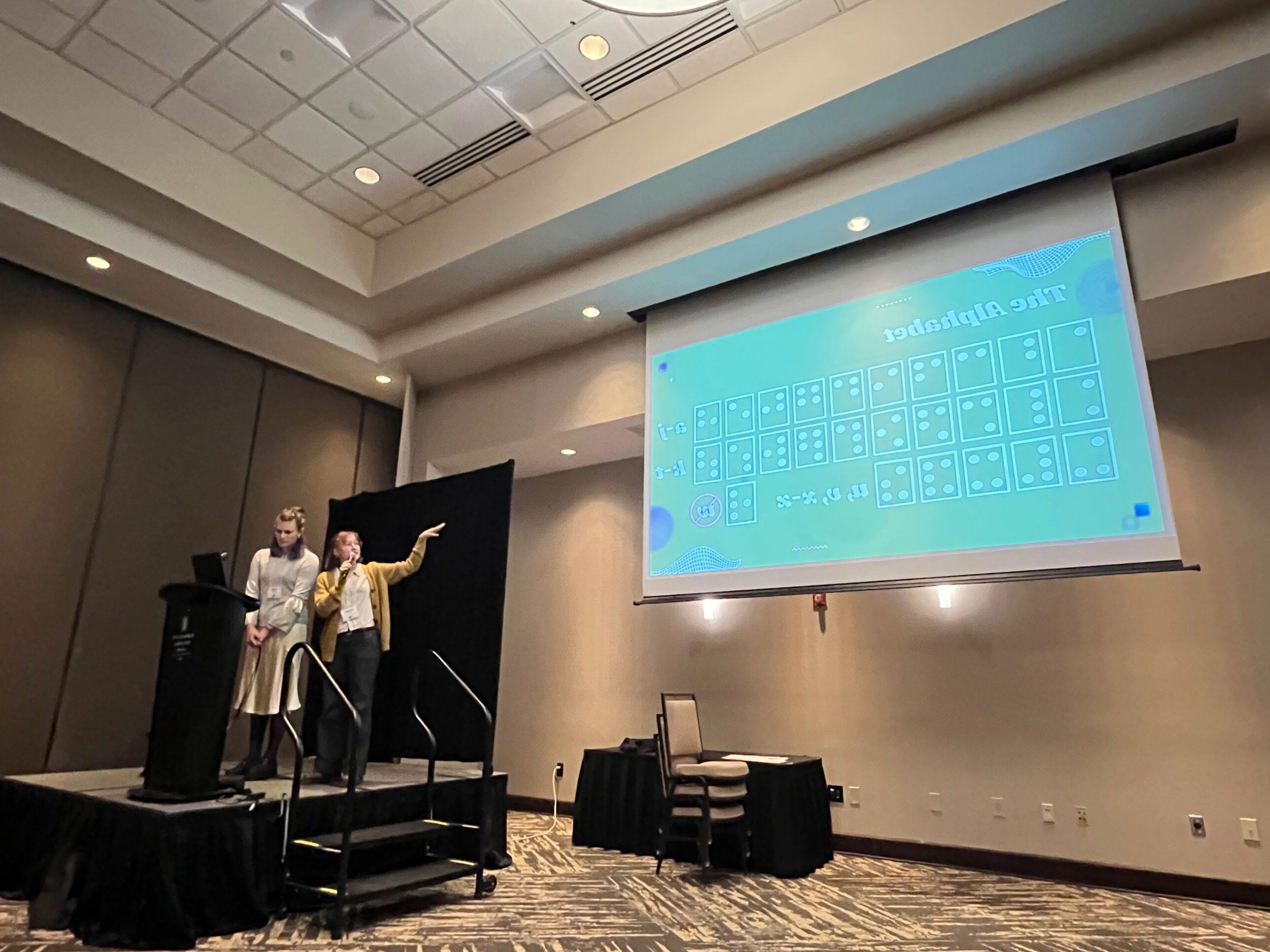 Two MSU math students, Matilyn and Violet, give a talk on their research at the 2025 Nebraska Conference for Undergraduate Women in Mathematics